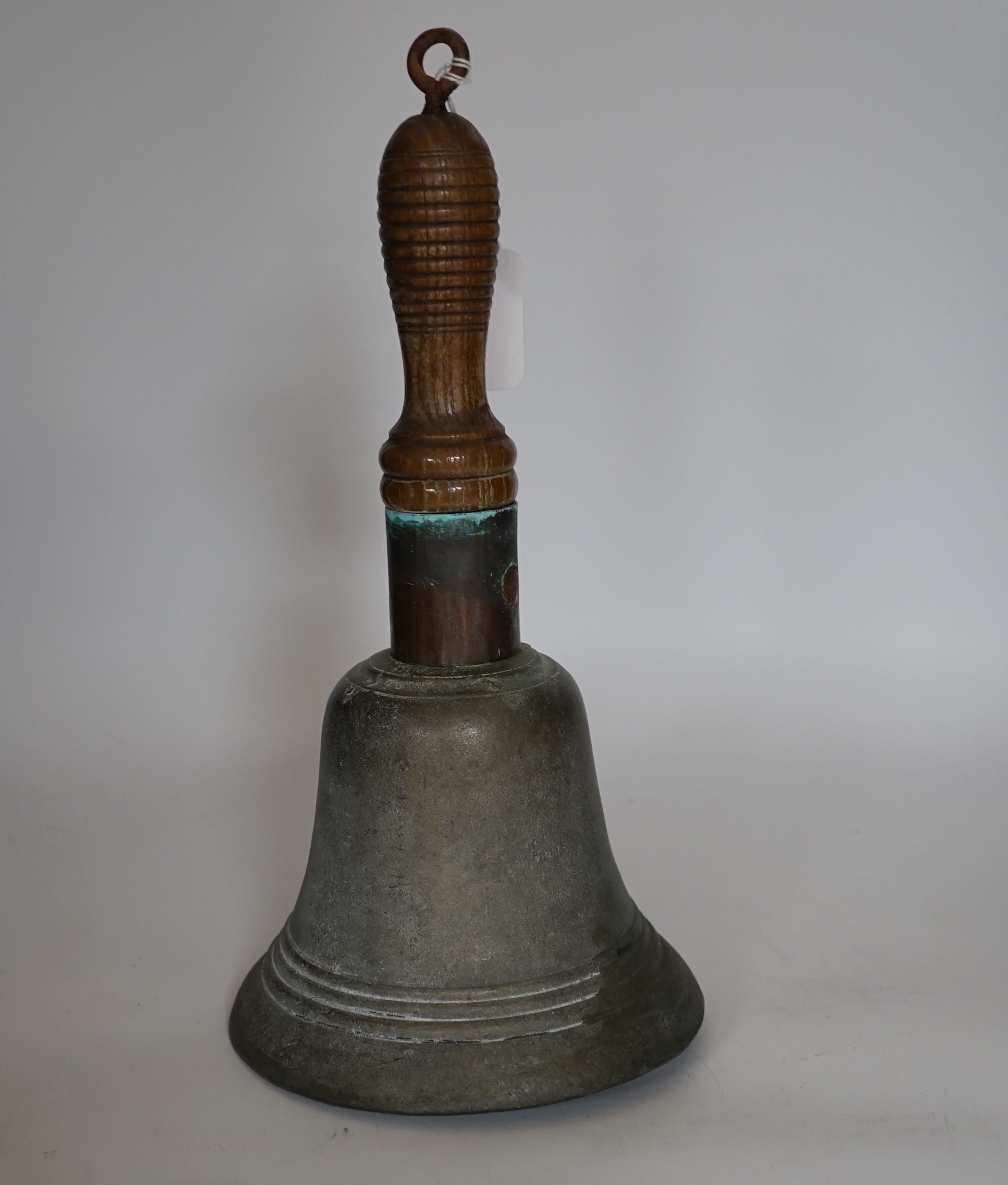 A bronze handbell with wooden handle, 31cm